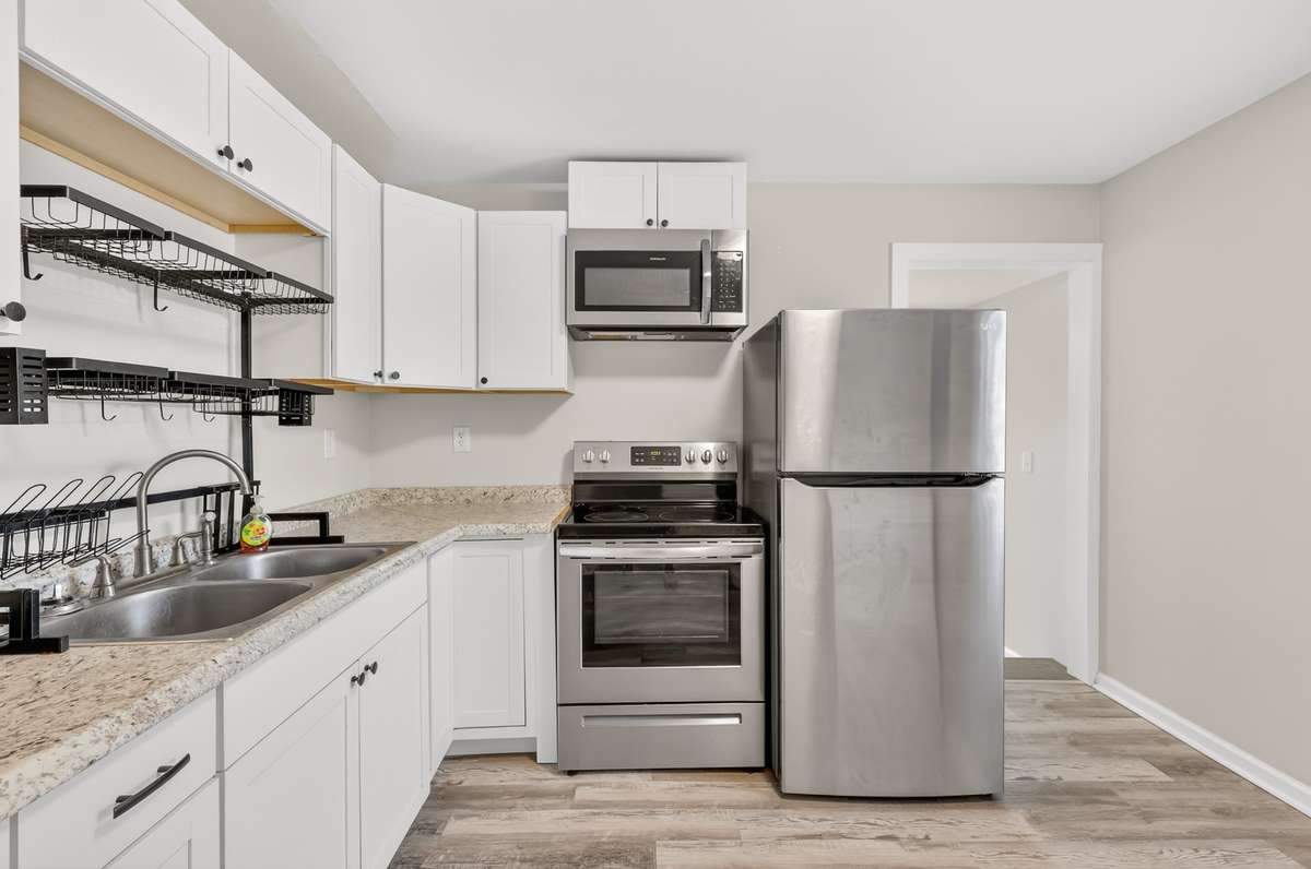 Plenty of cabinet space as well as double, deep sinks with a custom drying rack for dishes