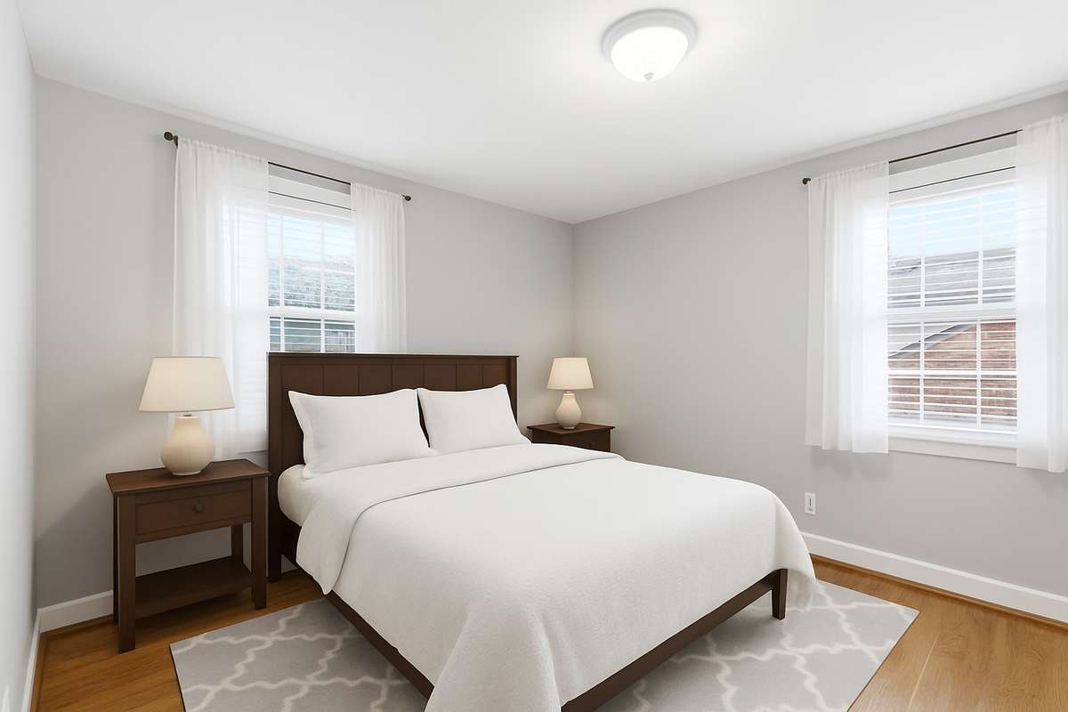 virtually staged guest bedroom on the main level.
