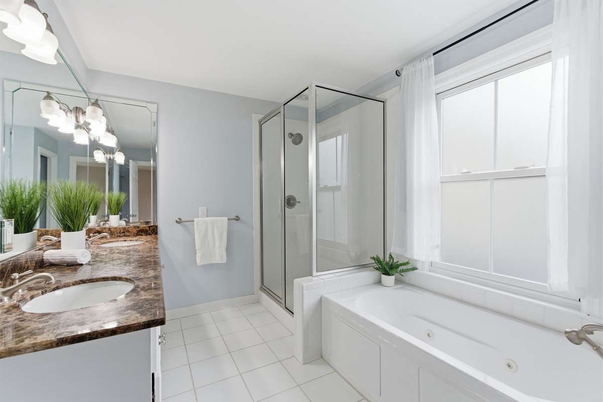 Primary bath with a separate shower and tub and a double vanity.