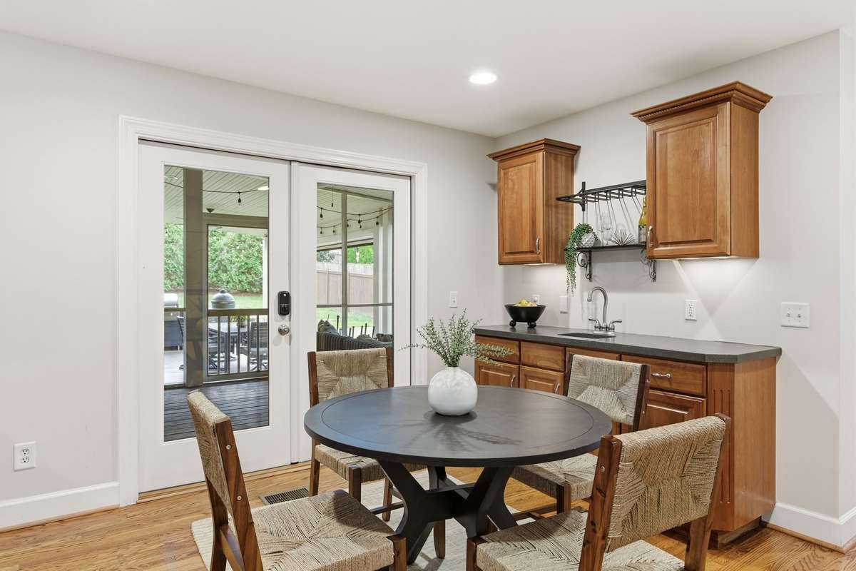 The breakfast nook overlooks the screened porch and the extra outdoor dining area.