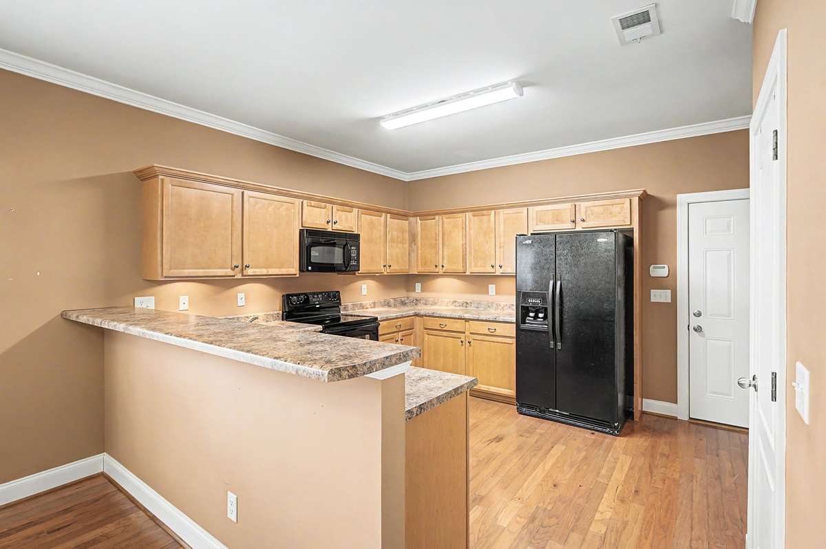 No steps from the garage to the kitchen. Abundance of cabinets, pantry, and raised bar.