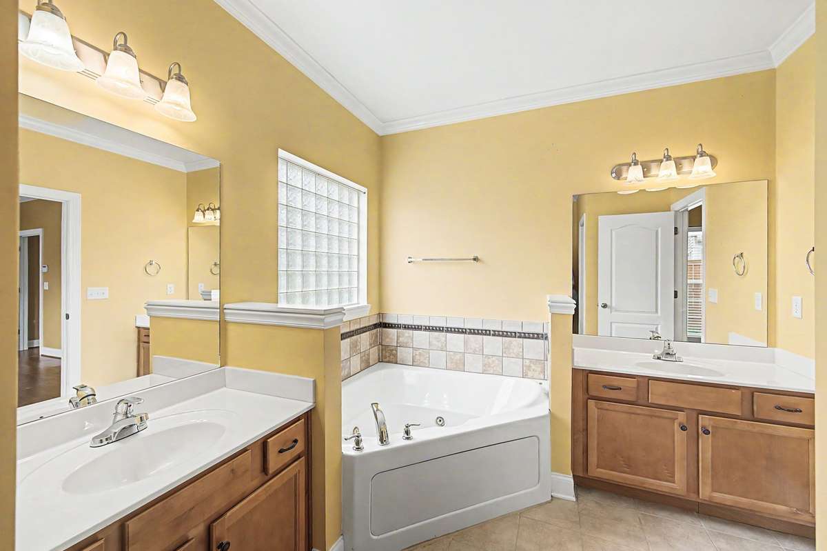 Primary suite features a soaking tub, double vanities, separate shower and water closet.