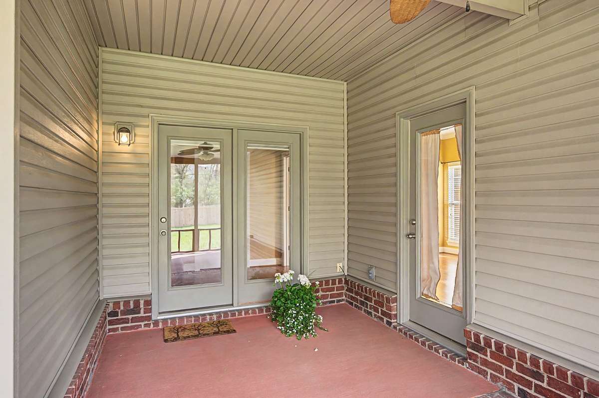 Screened porch is accessed by the hallway and the primary suite.