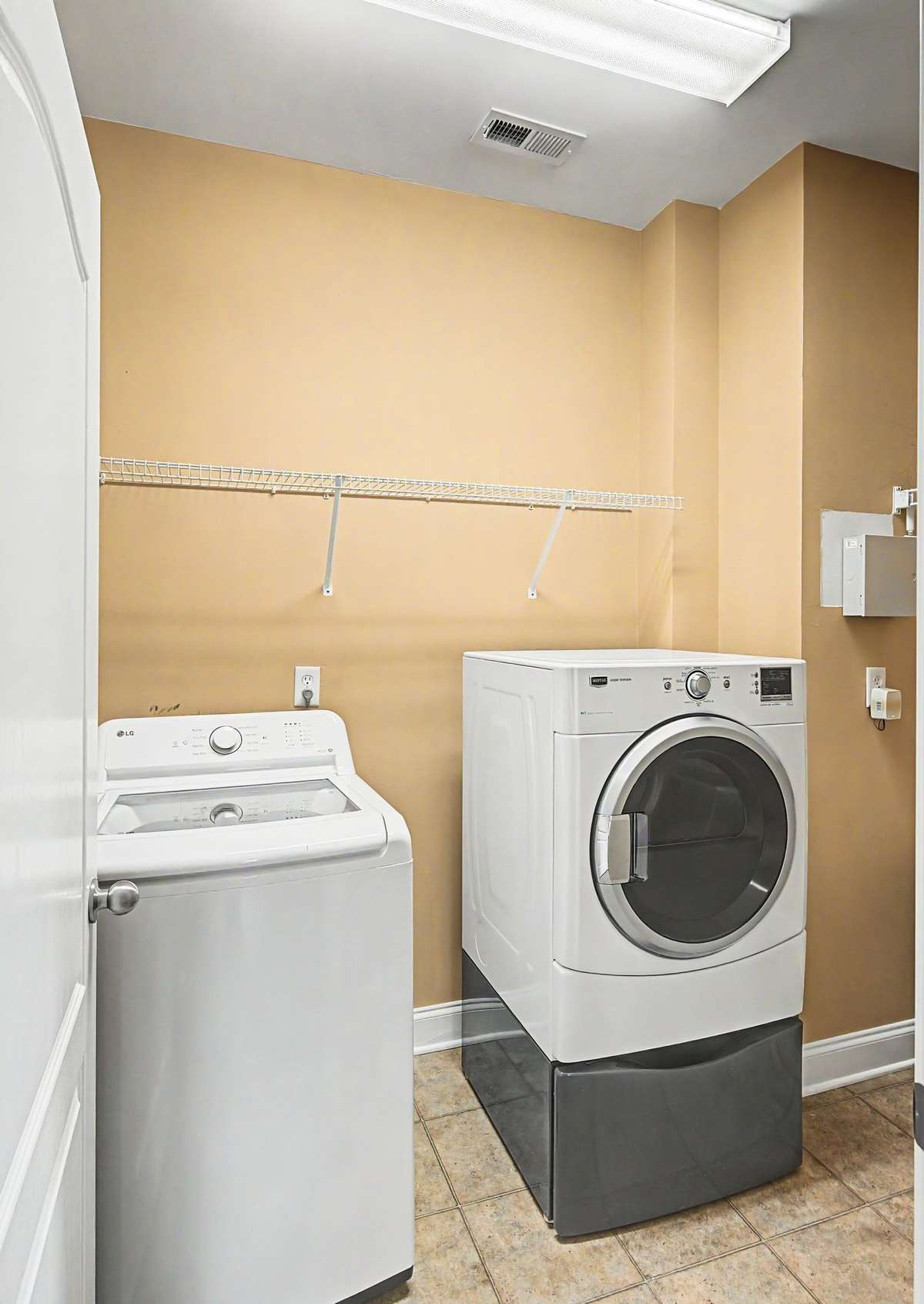Designated laundry room with washer and dryer remaining.