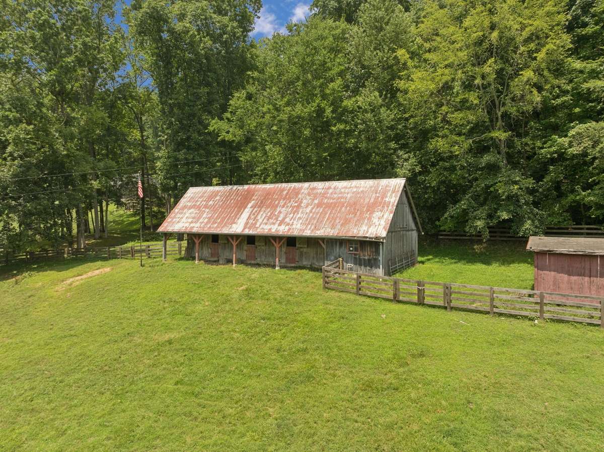 The property also features a charming four-stall barn with a tack room, ideal for equestrian pursuits or hobby farming.
