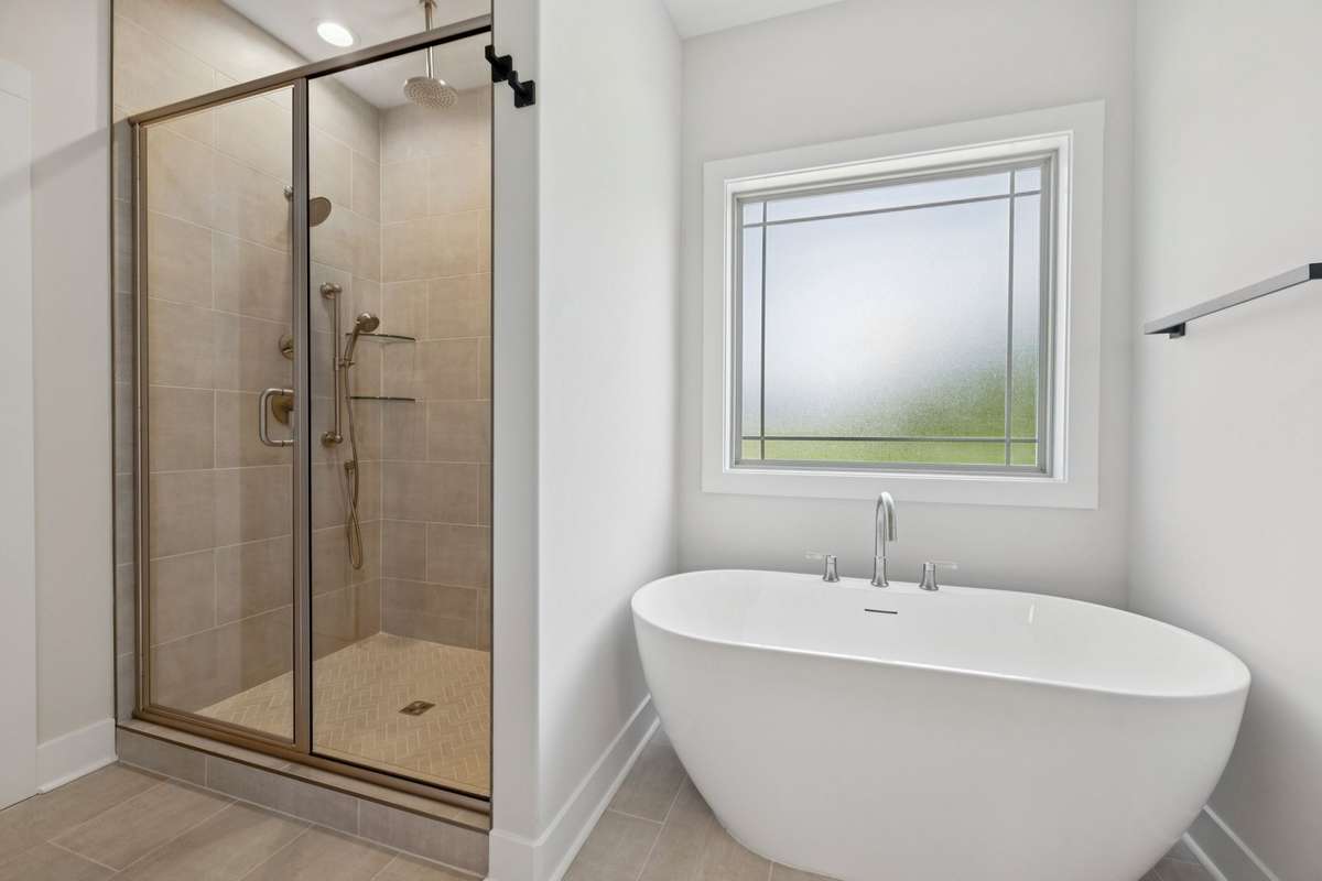 primary bathroom with shower and stand alone tub