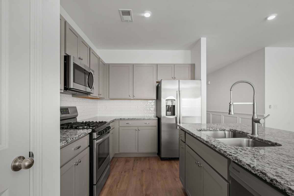 A large kitchen island and a gas range are big plus when it comes to a kitchen. Abundant cabinets for storage and amazing space to stretch out and prep those meals.