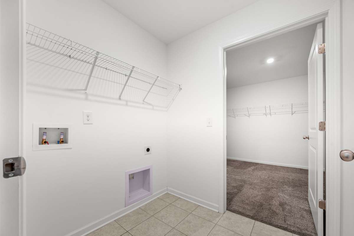 Having a laundry room with this much space makes doing laundry enjoyable. The door open in the photo is to the primary bedroom closet and a feature that many people absolutely love!