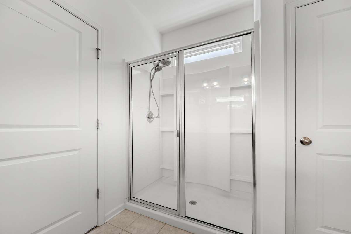 This primary shower feels fresh and modern, with clean lines, bright lighting, and a spacious glass enclosure that creates a calming, spa‑like feel. It’s a beautifully designed spot to start and end the day with a little peace.