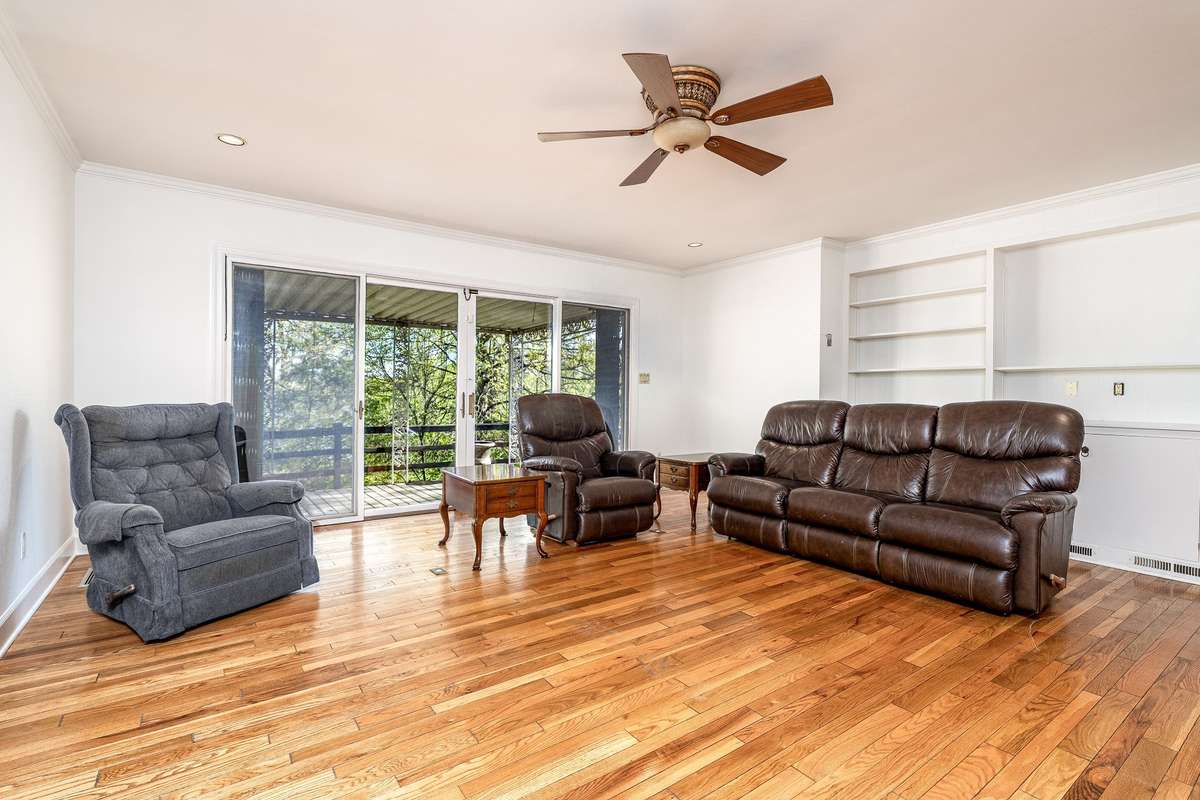 The back Den area has sliding doors leading to the back porch area and built in book shelves.