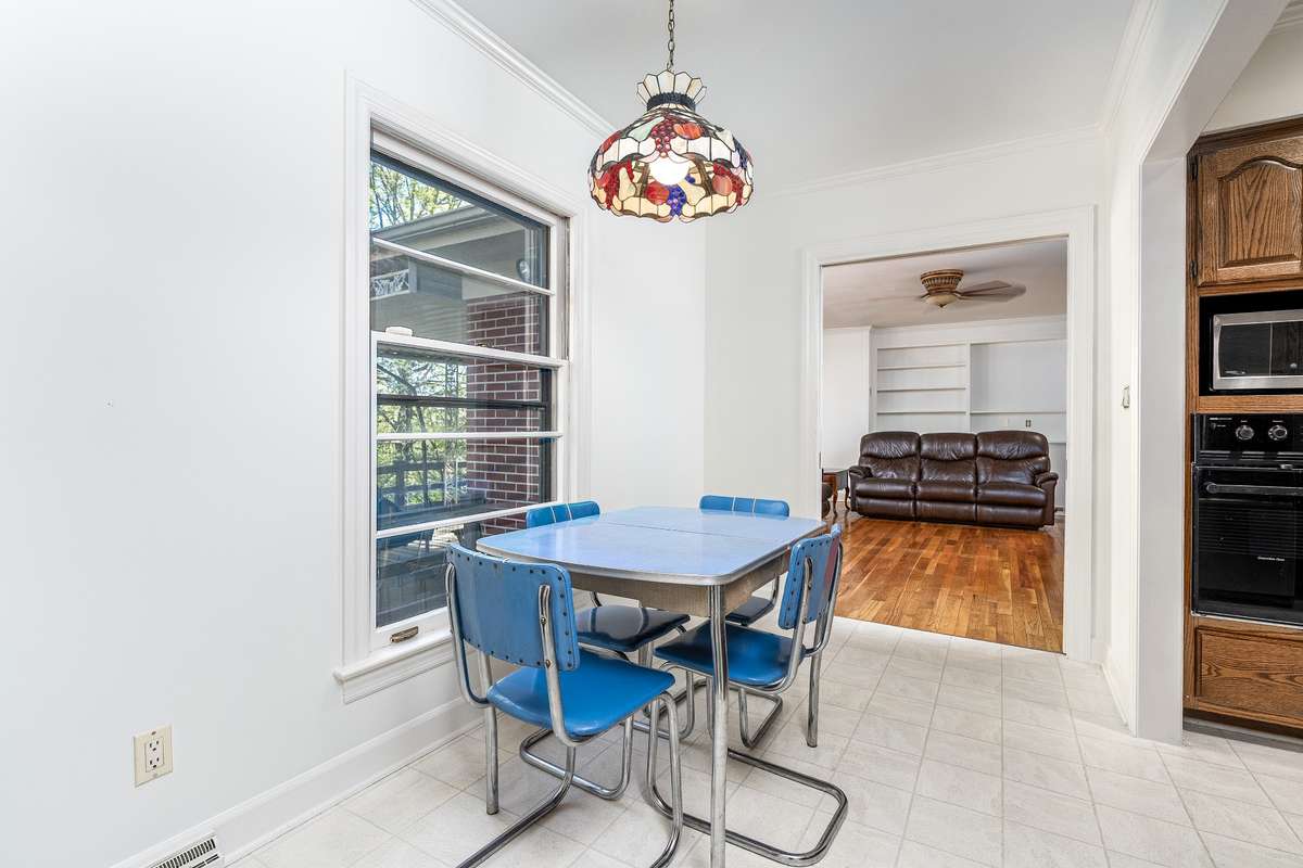 Eating area just off the Kitchen with natural light- a peek into the back Den