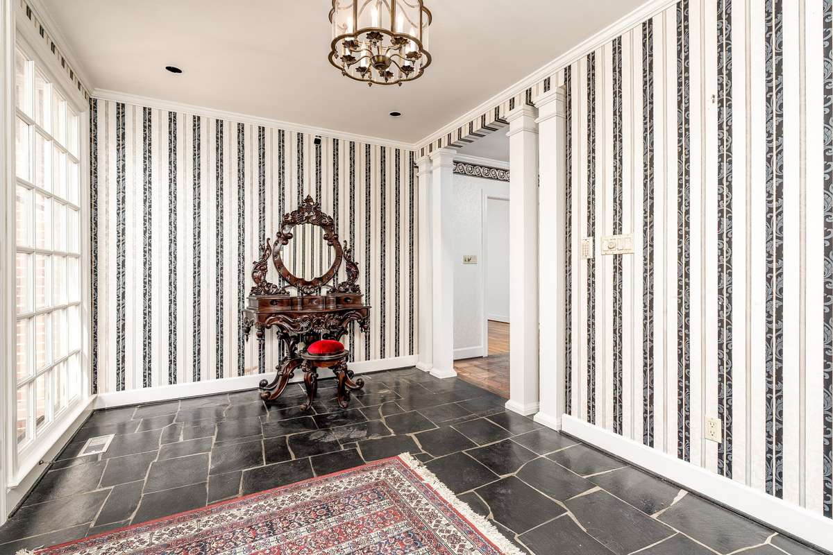 Entry with black slate tile and plenty of sunlight