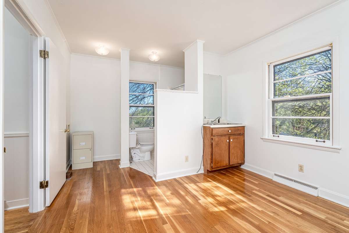 This could easily become the 4th Bedroom. This room was used as a "mother in law" suite with a full bath, washer/dryer hook ups and sink