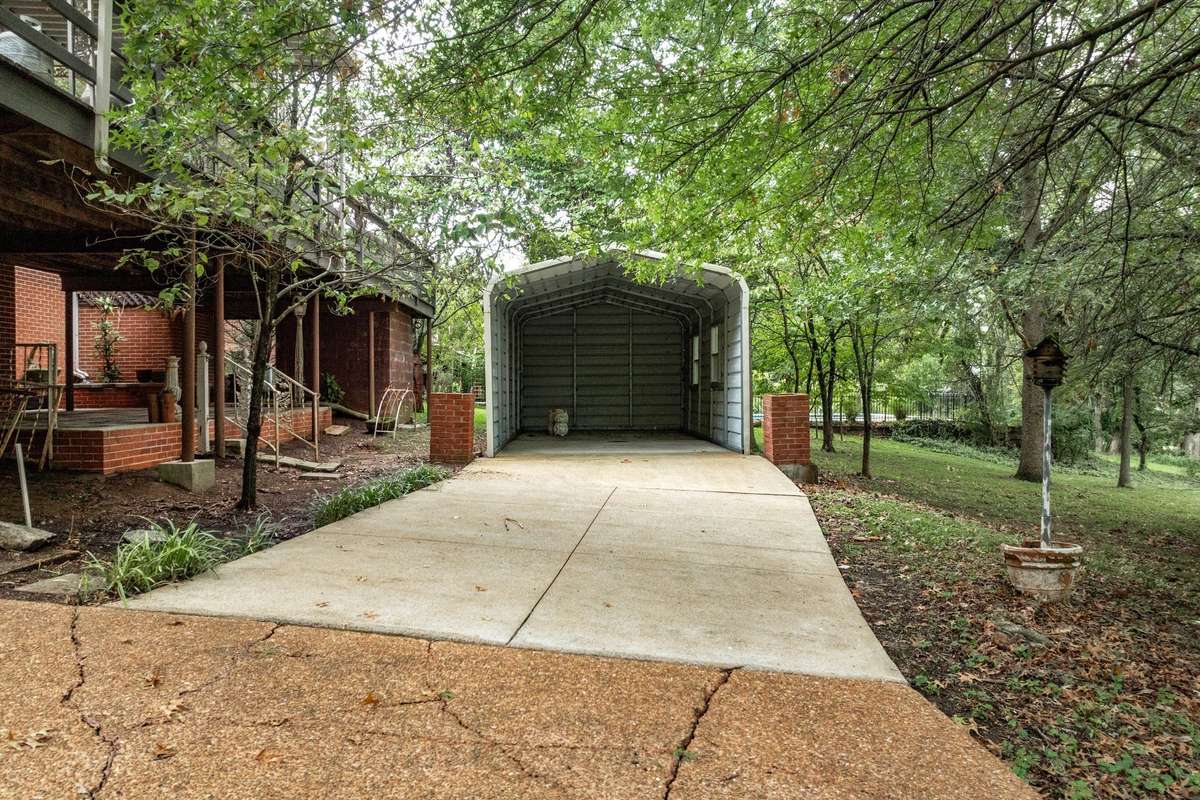 Concrete drive leading to Covered Carport