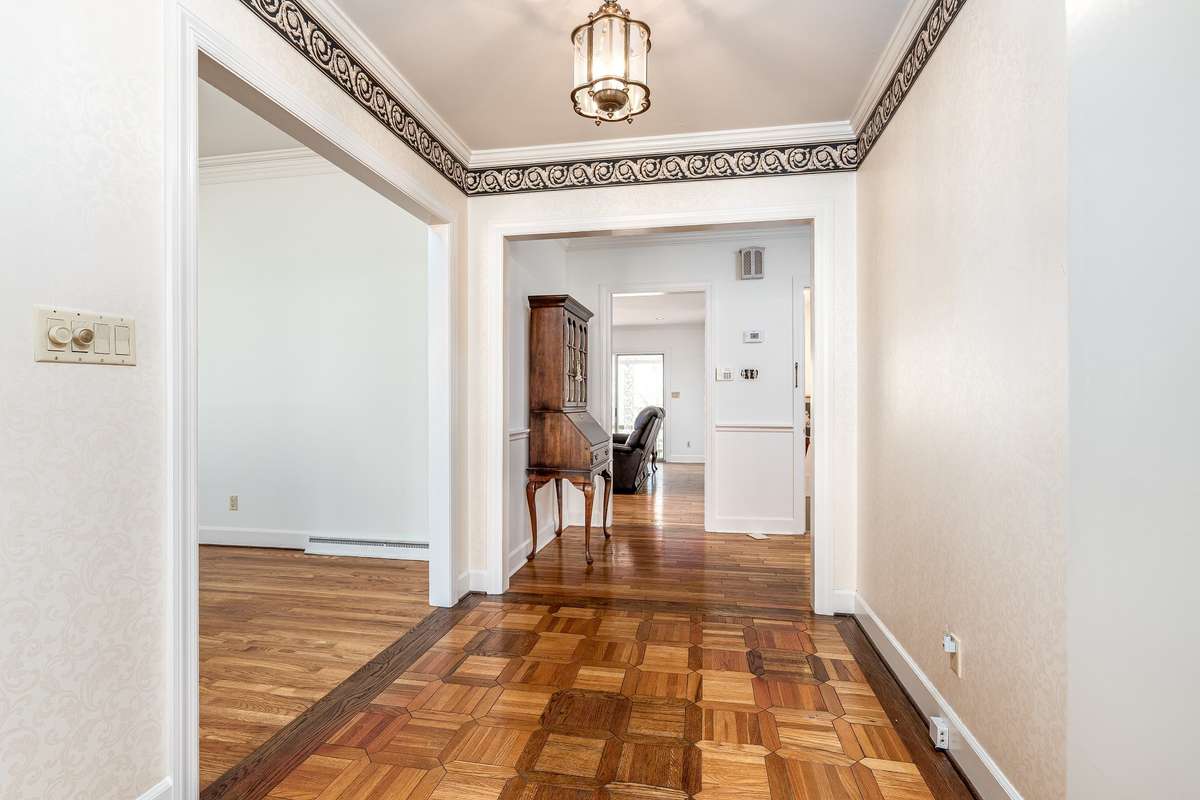 Entry Hall leading to the Front Family Room and Back Den- Both with fireplaces and gas logs