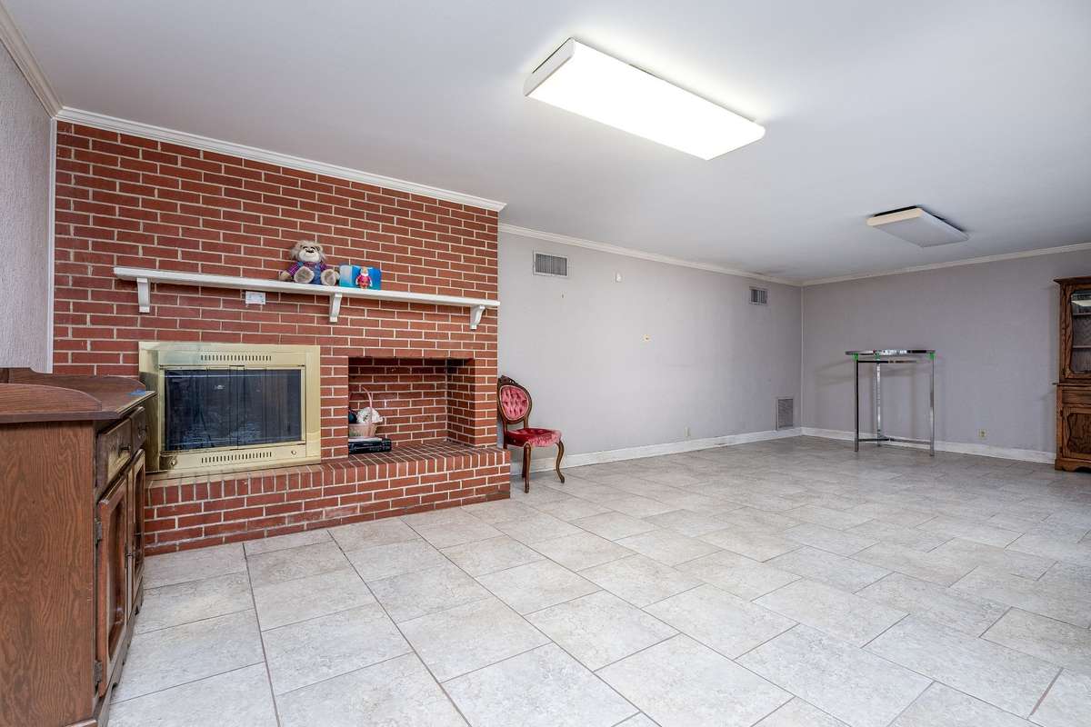 Another view of Bonus Room in the Basement with fireplace and gas logs
