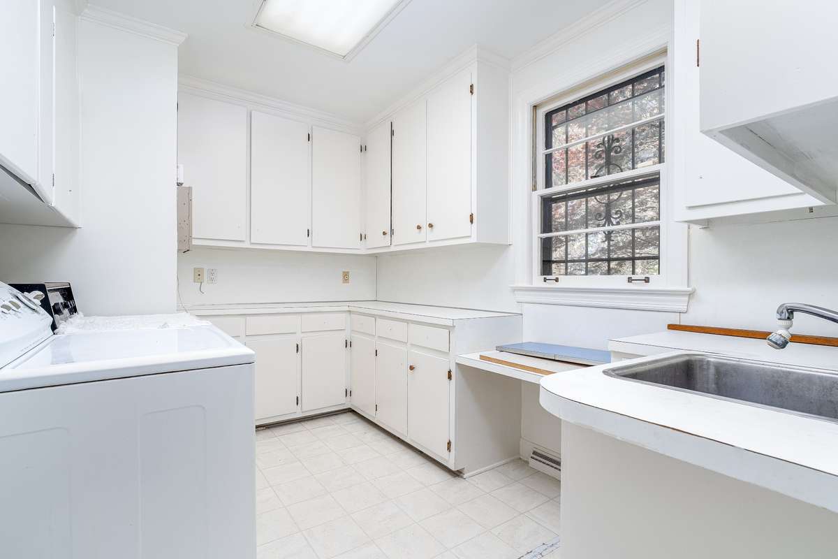 Spacious Laundry Room with cabinets and sink