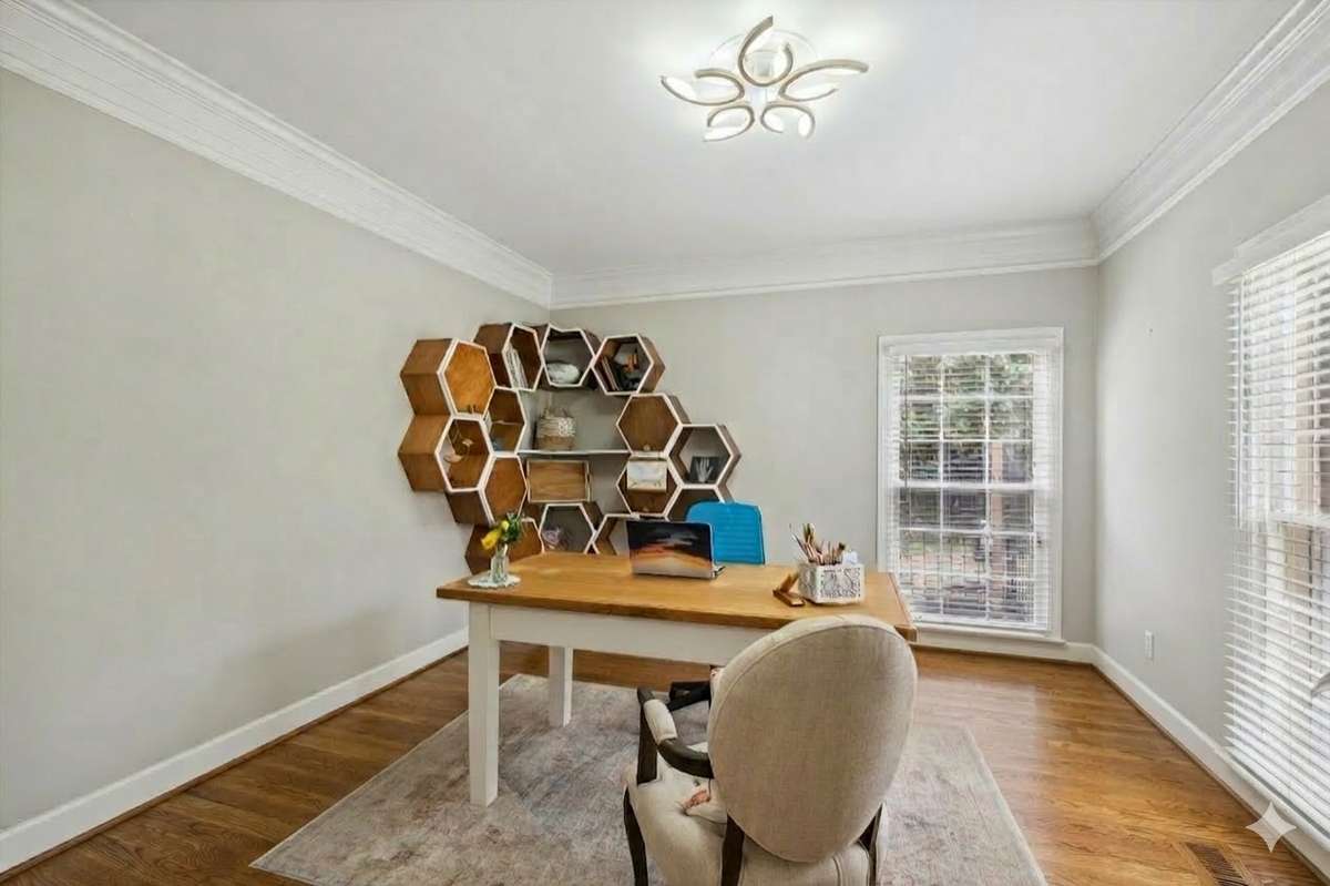 Off the entry is a home office with great natural light and French doors for privacy. The honeycomb bookshelves do not remain.