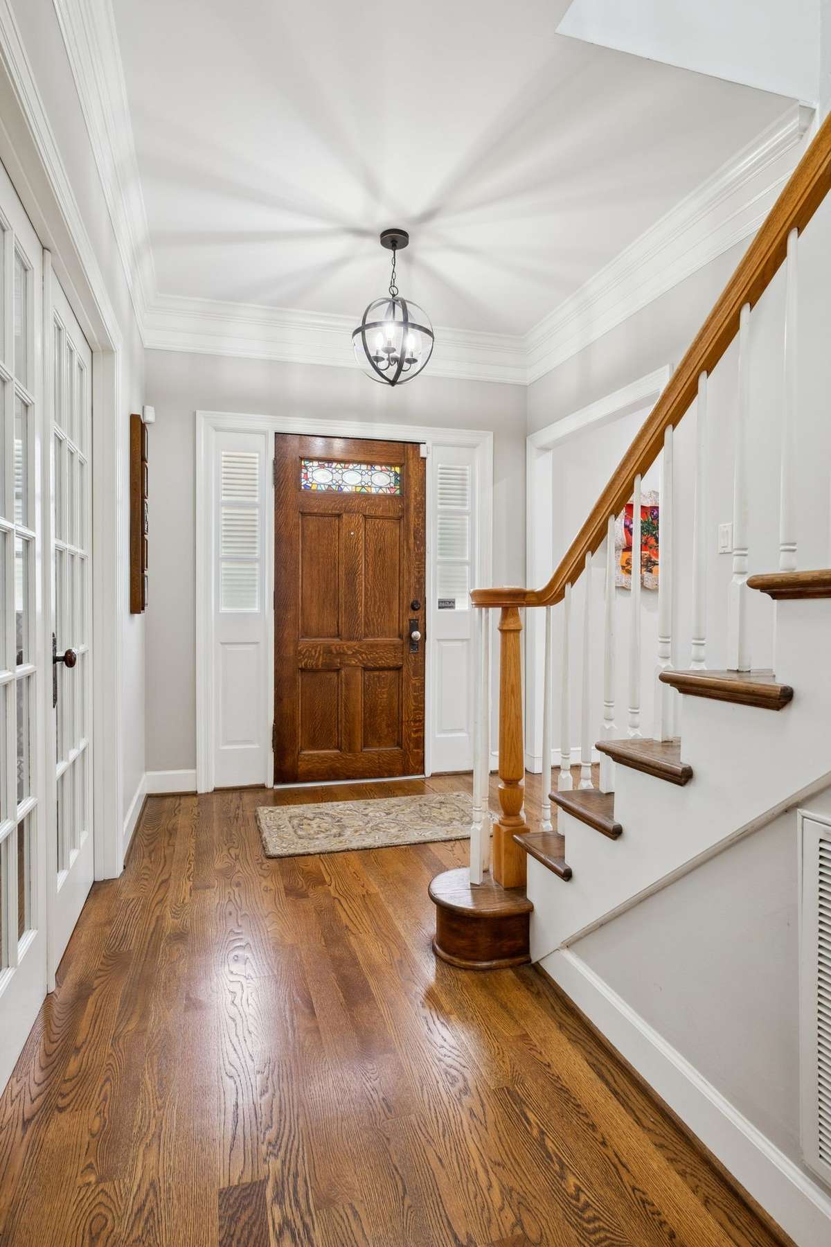 The antique stained glass front door does not remain and will be replaced with the original door prior to closing.