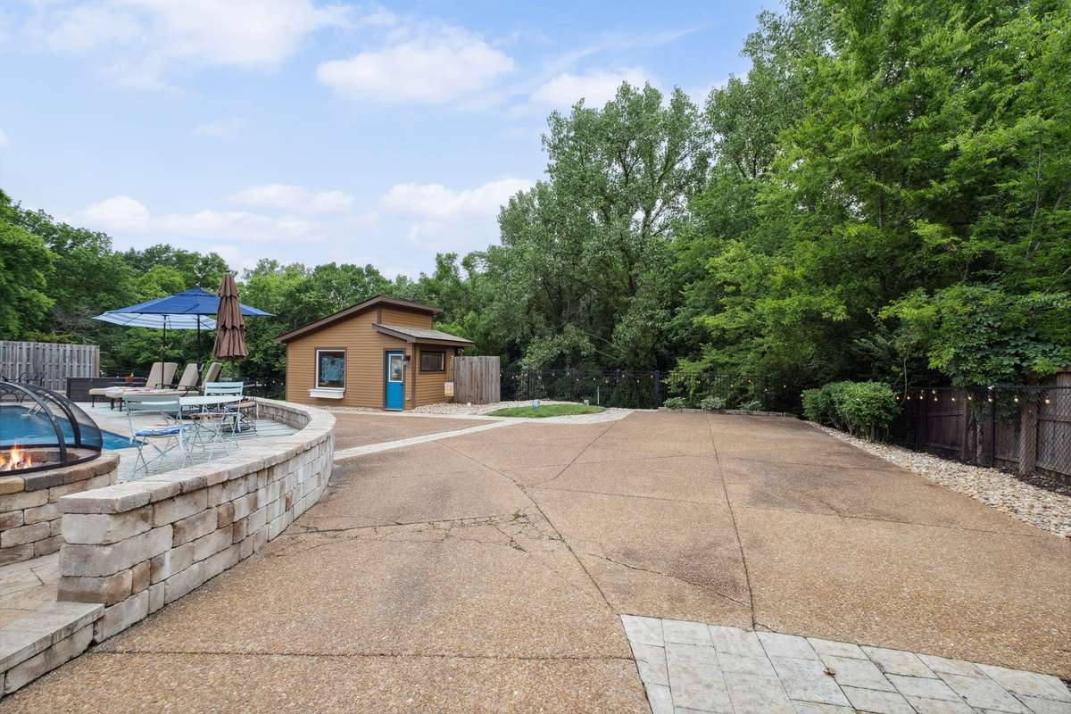 The yard is fully fenced for security and the lush tree line provides privacy.