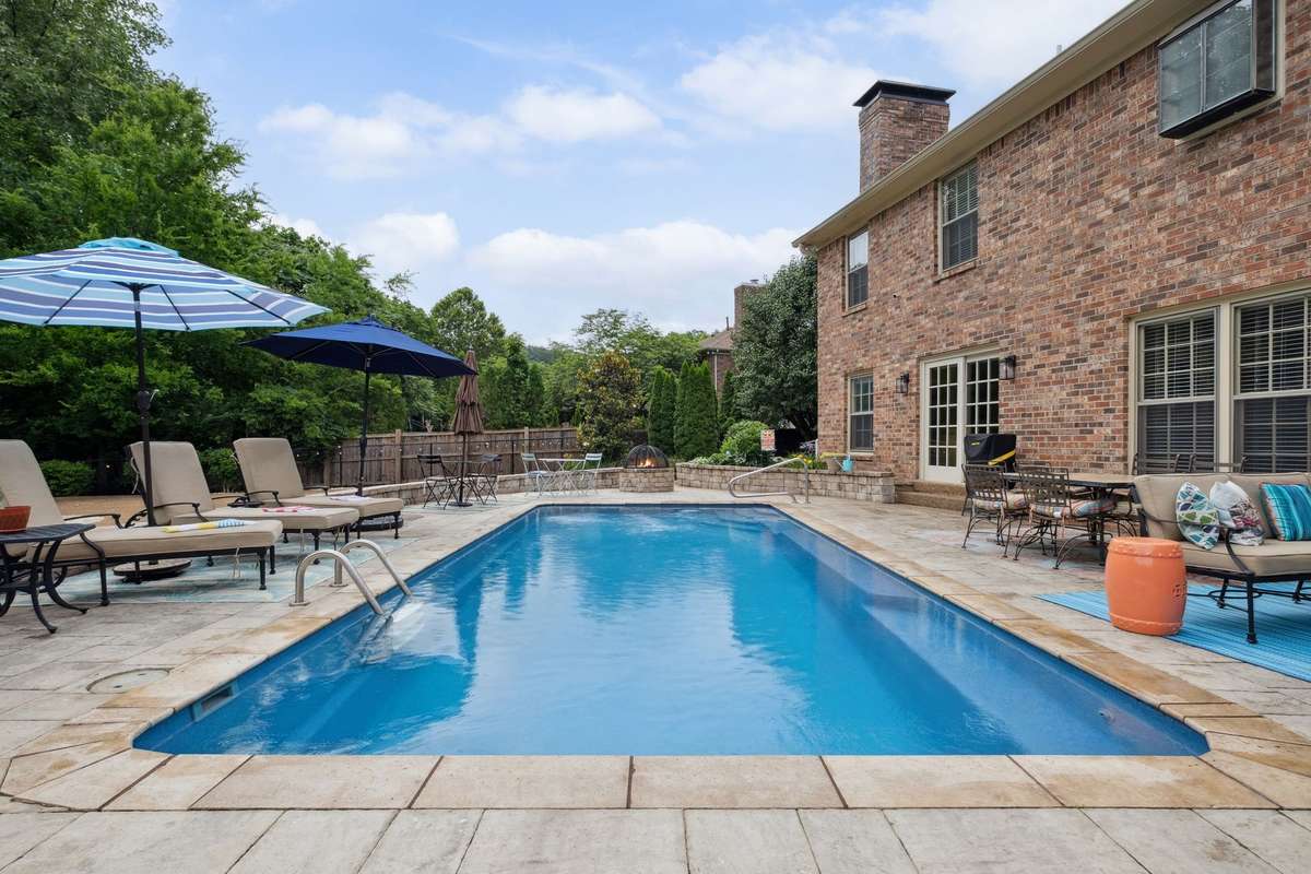 Enjoy your very own backyard oasis that was built in 2021 with a heated pool, gas fire pit, outdoor kitchen and pool house.