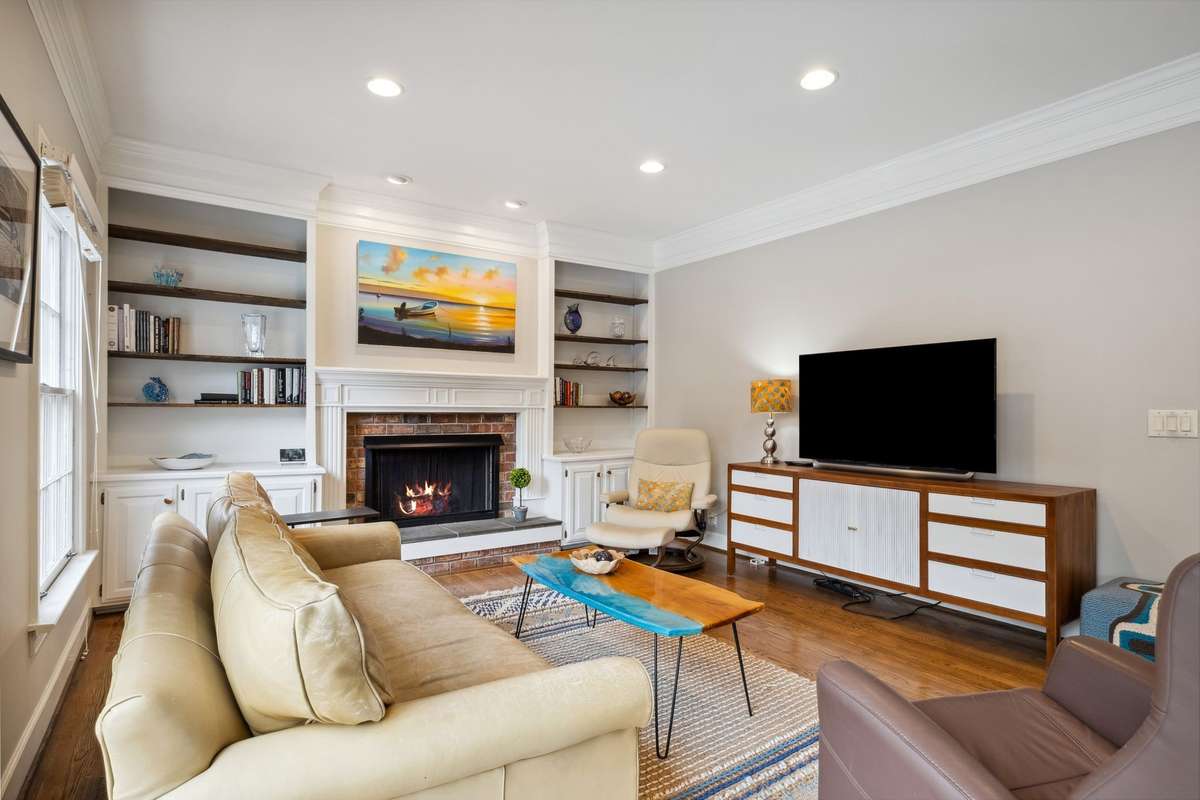 The gas fireplace is flanked by built-in bookshelves and cabinets for display and added storage.