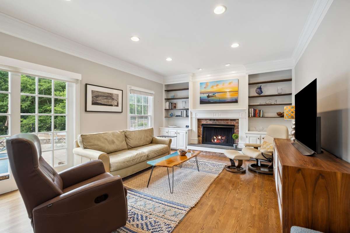 The cozy den in the back of home has Anderson sliding glass doors that open to the pool.