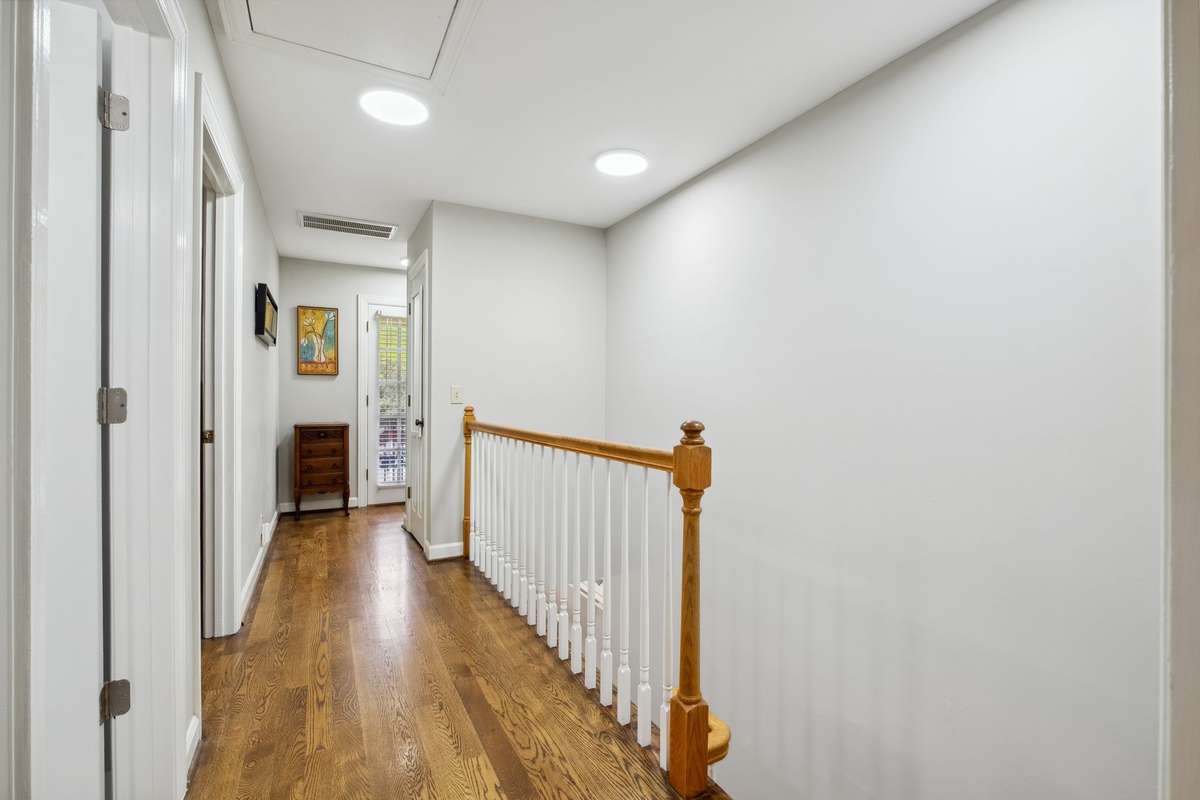 The hardwood floors continue up the stairs and throughout the second floor. There is a large closet in the hall for additional storage and a door leading to the balcony.