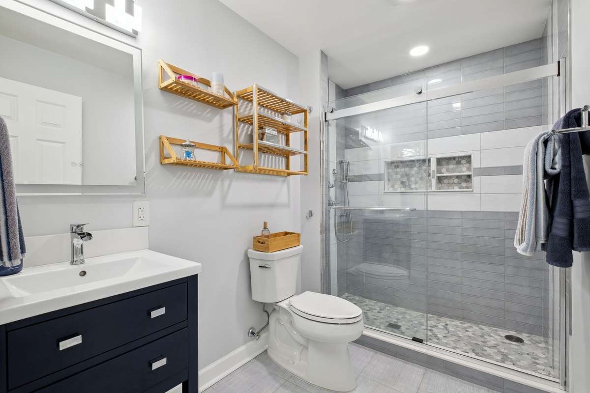 The hall bath has been completely remodeled with new ceramic tile, vanity, LED lighted mirror and fixtures.