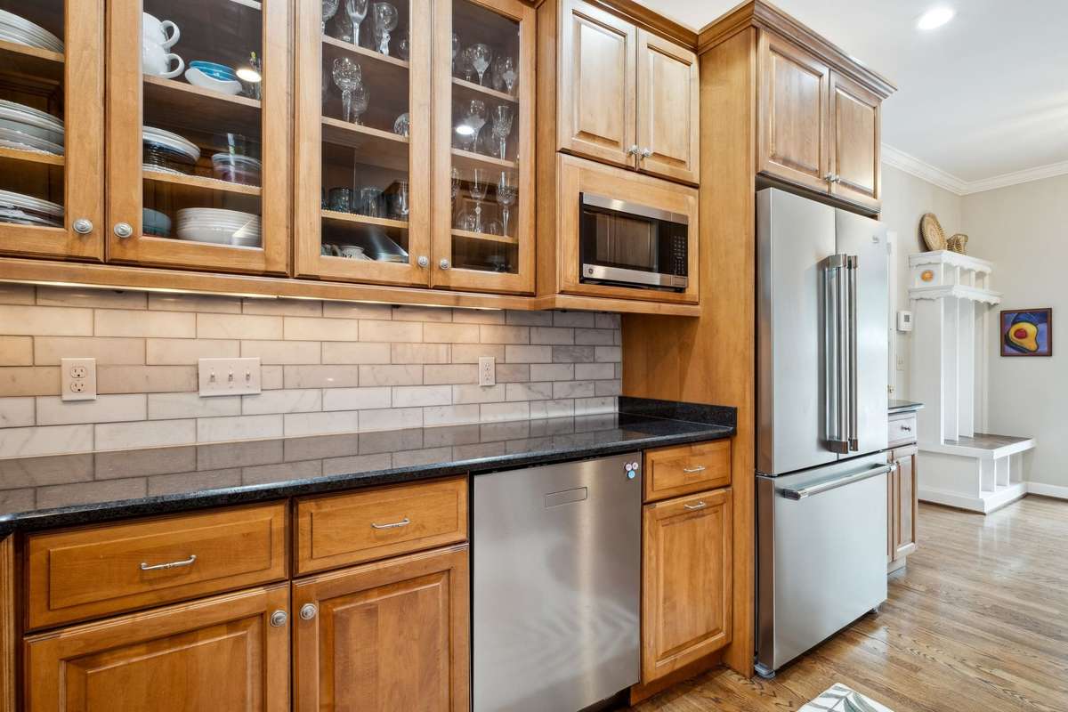There is a GE microwave and Beko French door counter depth refrigerator (2024).