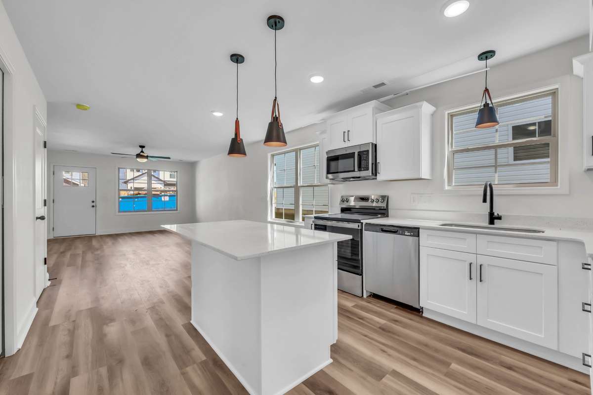 Gorgeous kitchen with white cabinets, granite counters and stainless steel appliances