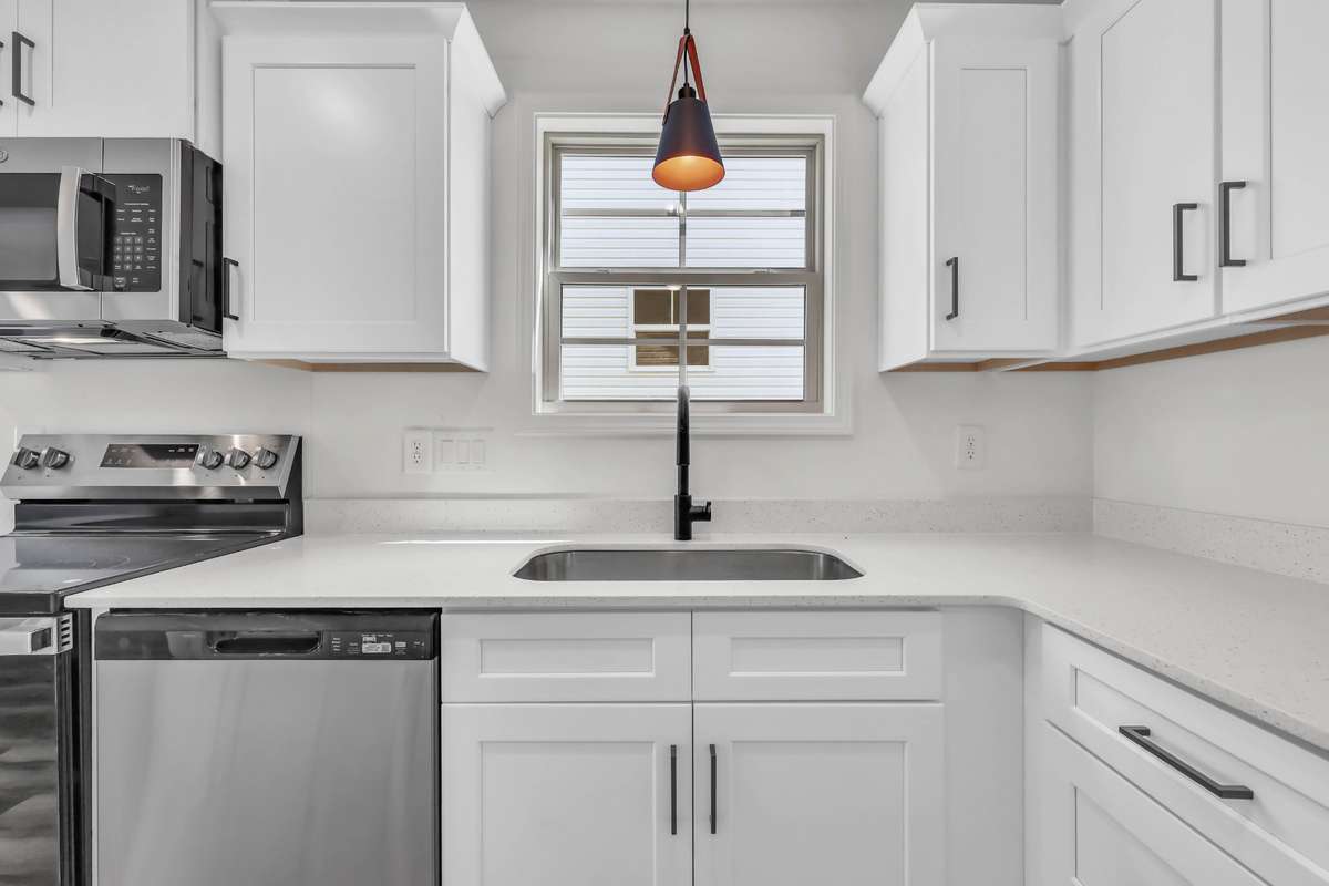 Gorgeous kitchen with white cabinets, granite counters and stainless steel appliances