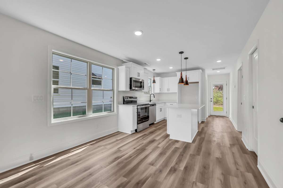 Gorgeous kitchen with white cabinets, granite counters and stainless steel appliances