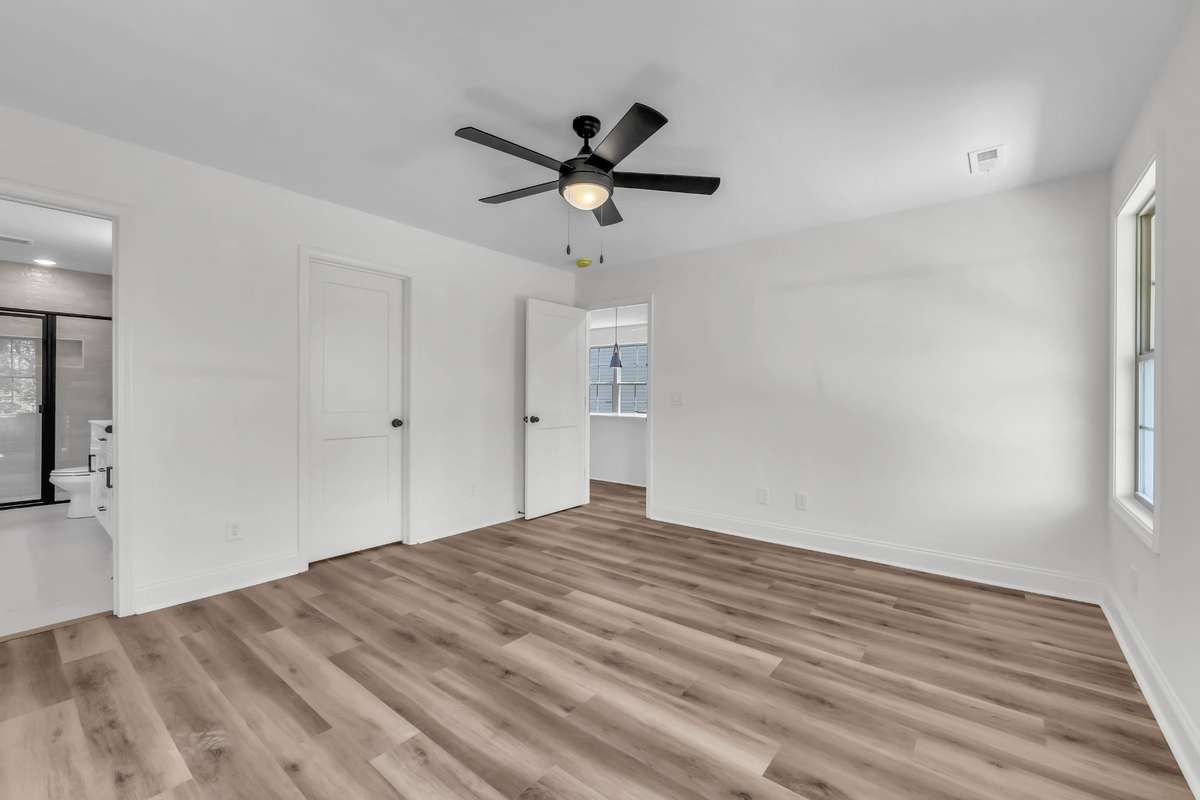 Master suite on the main level with ful bathroom, walk-in closet, ceiling fan and LVP flooring