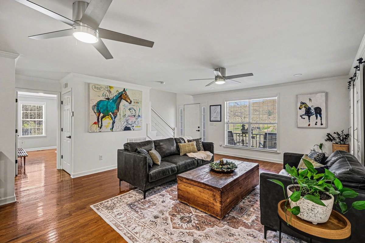 The half bath as well as the primary suite is tucked just off of the living room