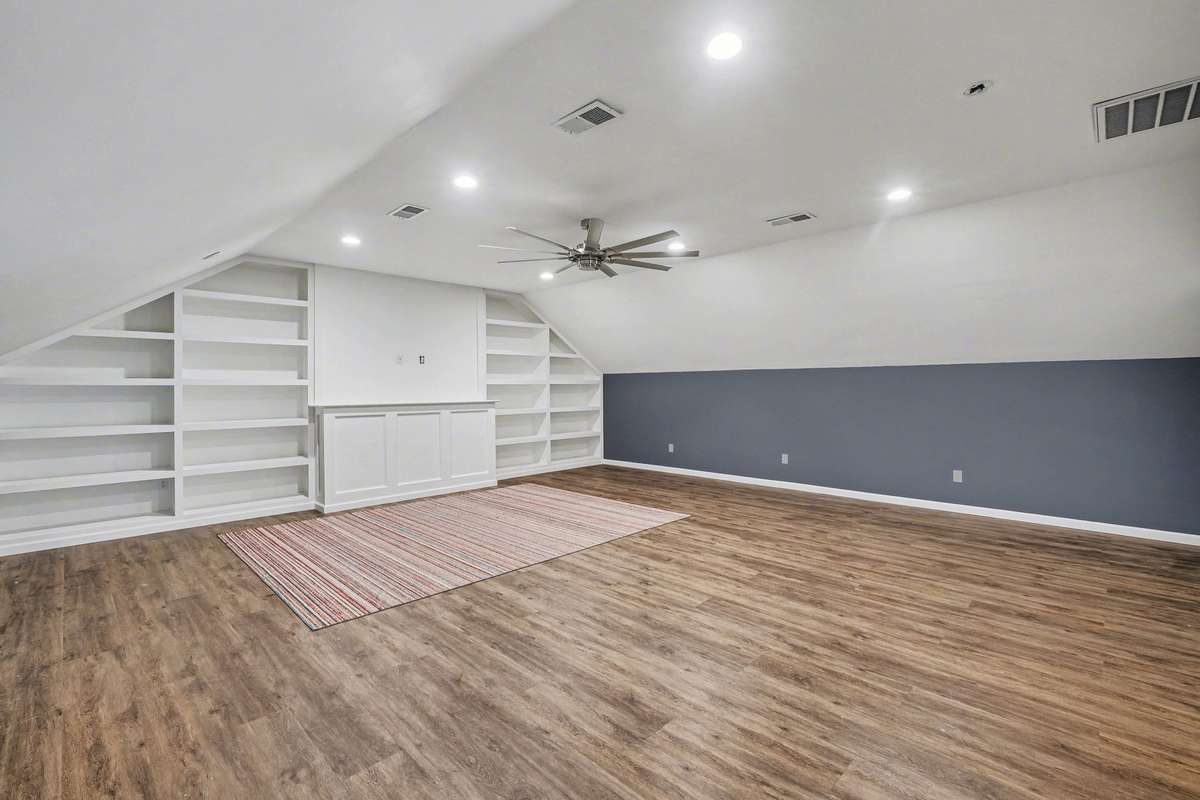 Extra large bonus room, off of the mud room on its own side of the house from the other bedrooms and living area. It also has new flooring with new fan, built in shelving and it's own half bath