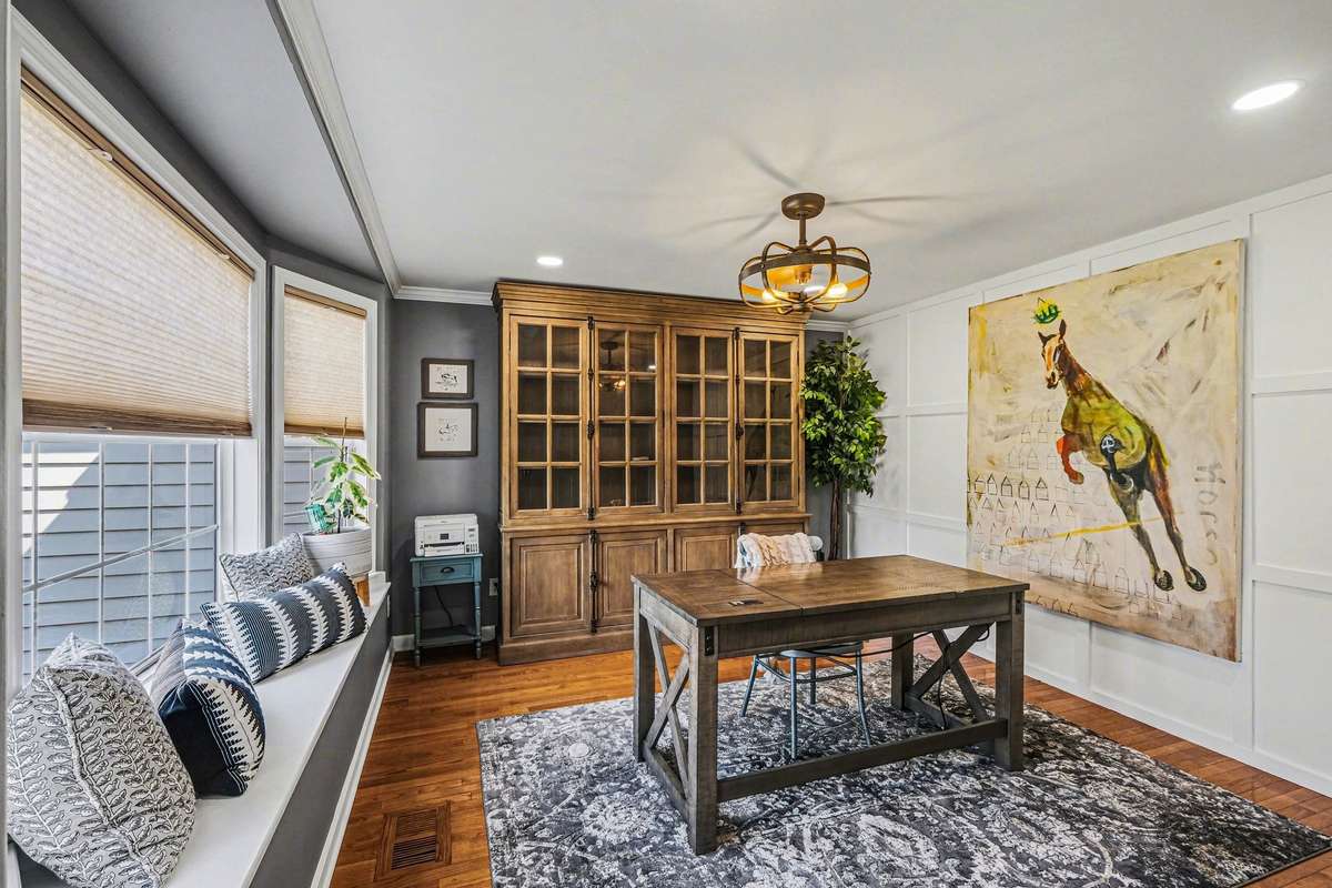 This room located in the front of the home, just off the living room has versatility, it could be an office, formal dining or a library. So many rooms have touches of customization, like this one with the wood trim and window seat