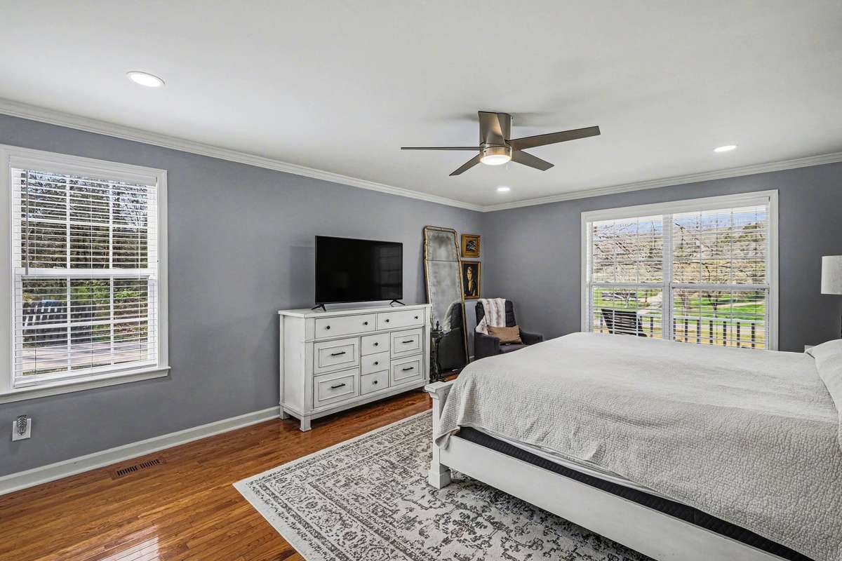 Over sized primary bedroom just off the living room, notice how the wood floors go throughout this level
