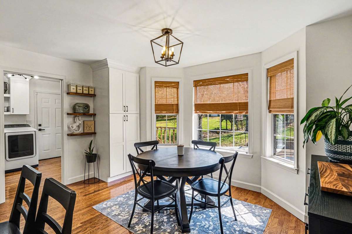 Through the eat in kitchen is the laundry/mudroom with entrance from the 3 car garage- Notice all the new matching window treatments and customized  lights throughout the house