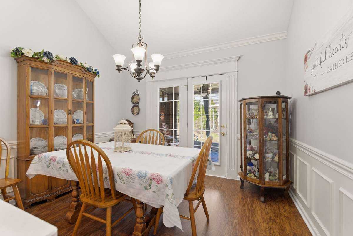 Dining area overlooks back covered porch.  Laminate Hardwood flooring and new light fixtures