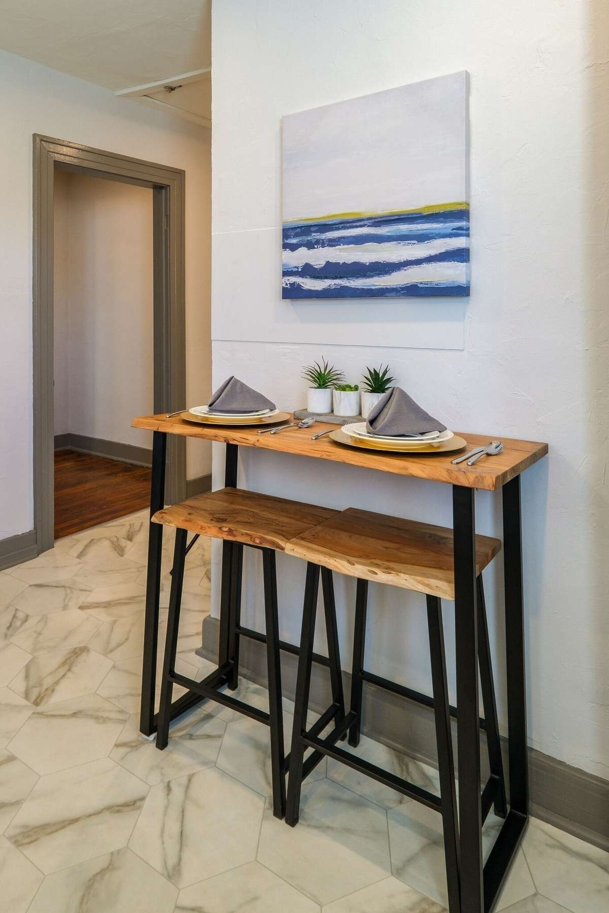 Unit A:  The kitchen offers access to the laundry room and hallway, plus room for a breakfast bar. Photo from 2021.