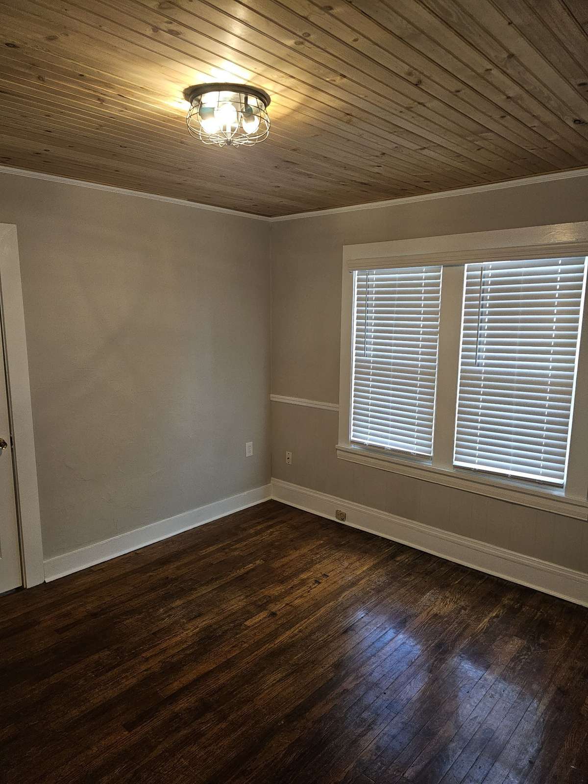 Unit B Bedroom: hardwood floors, tongue-in-groove ceiling installed 2023, updated light fixture