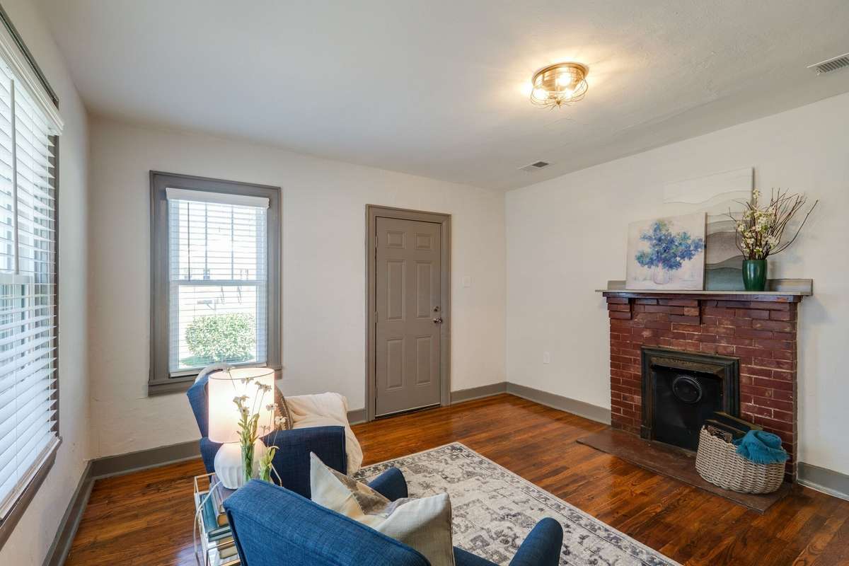 Unit A: Original hardwood flooring lends additional warmth to this light-filled space. Photo from 2021
