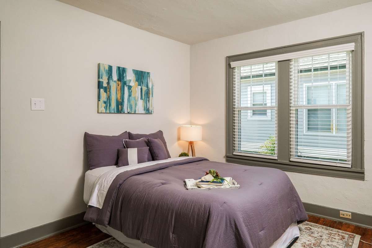 Unit A: The bedroom offers windows and blinds [replaced in 2021] and room for a queen size bed. Photo from 2021
