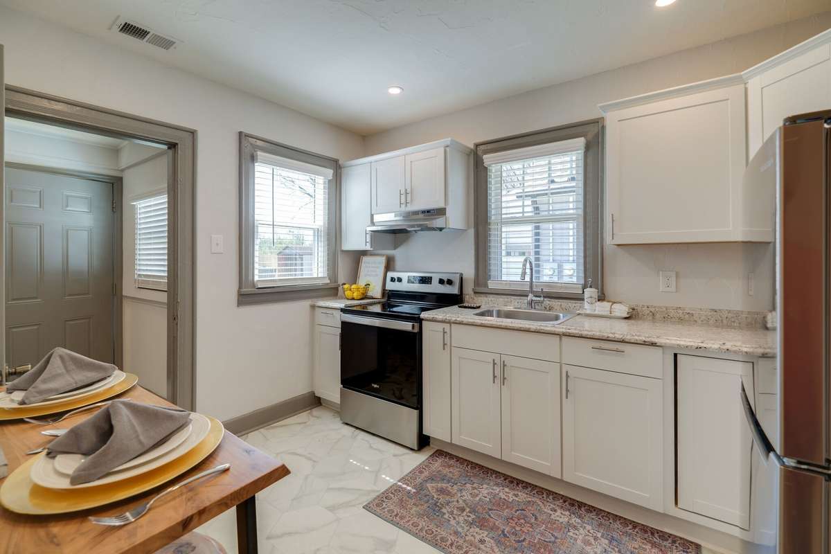 Unit A: Stunning eat-in kitchen with updated lighting, windows, cabinets, appliances, and flooring.  Photo from 2021