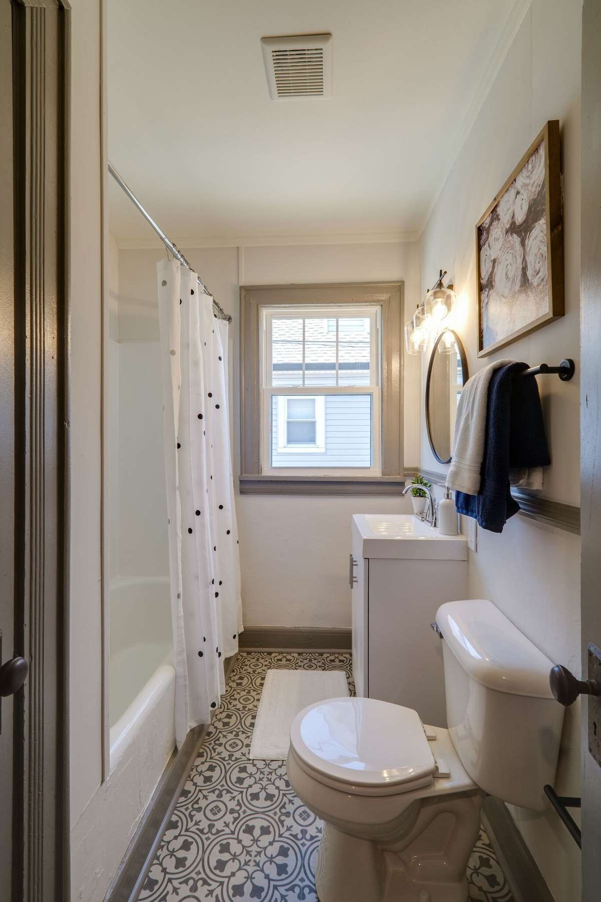 Unit A:  This beautiful bathroom offers a closet and updated fixtures, vanity, flooring, and toilet.  2021 Photo.
