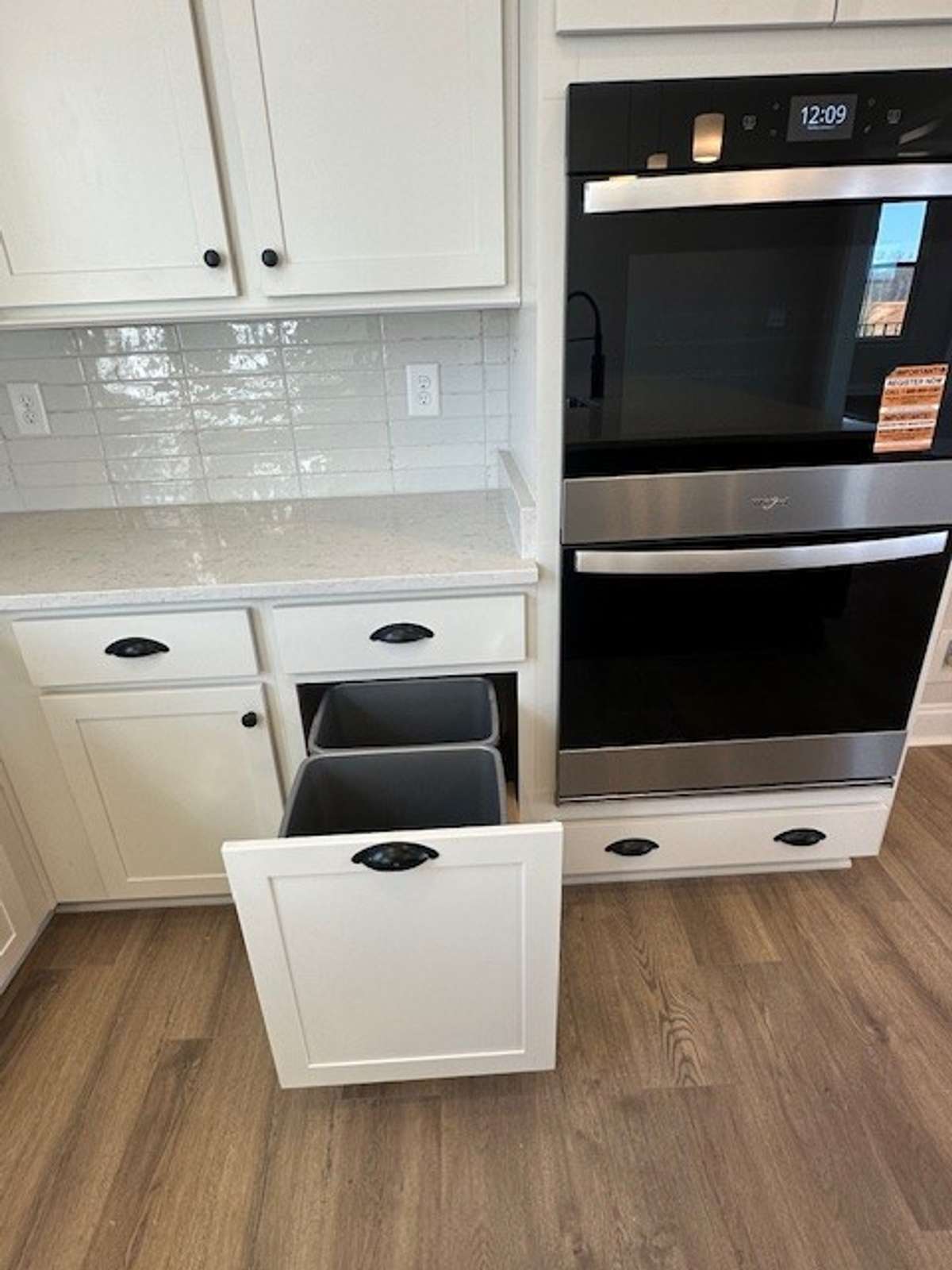 Check out the handy trash can roll out cabinet in your Kitchen!