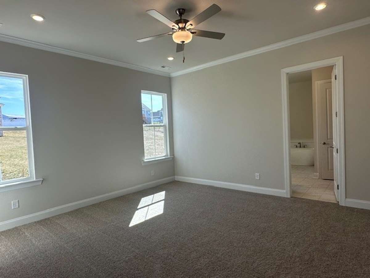 Primary Bedroom on the main level really shows off the 10' ceiling height and 8' doors!