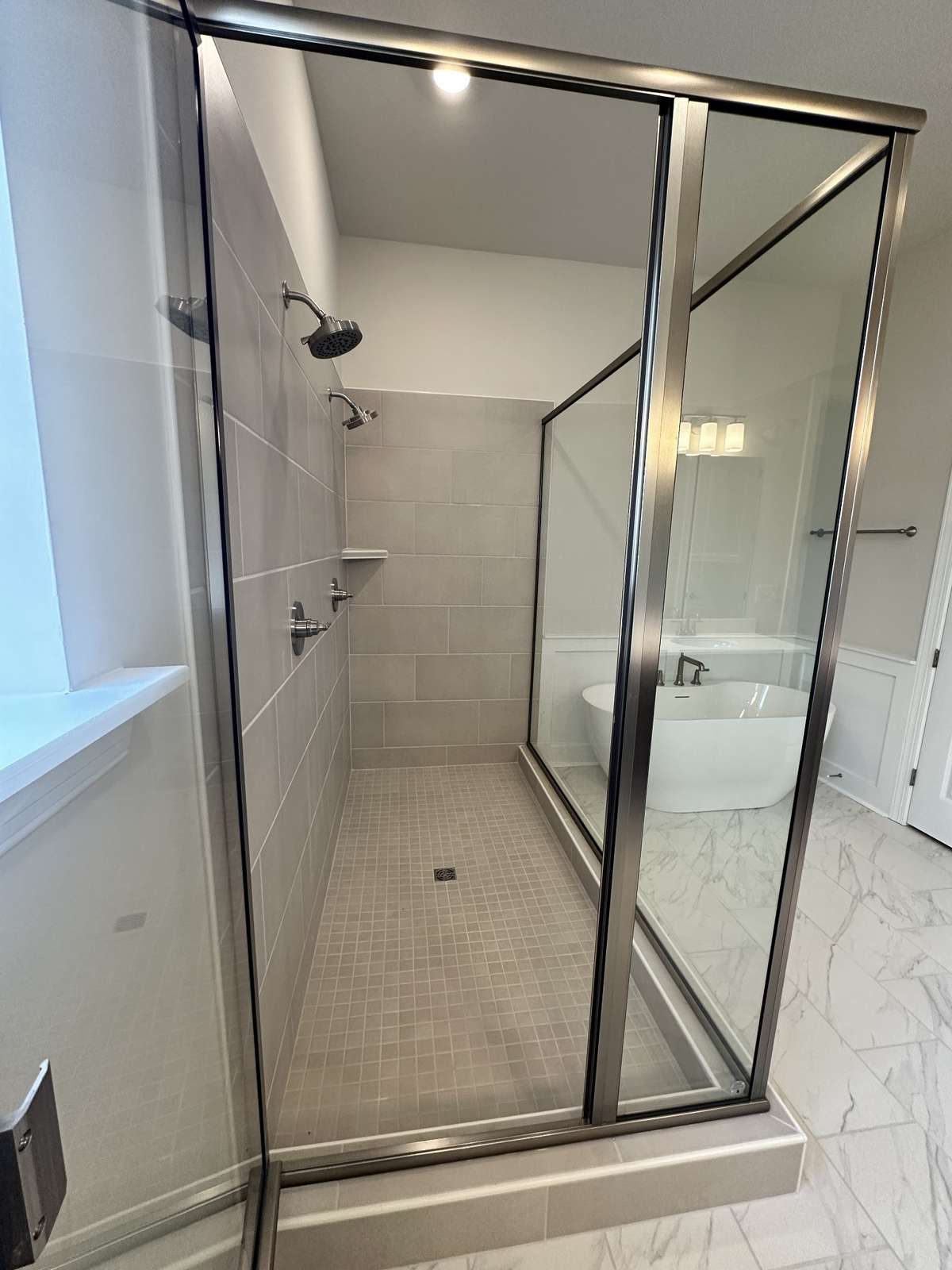 2 shower heads and beautiful tile make your walk in shower so inviting!