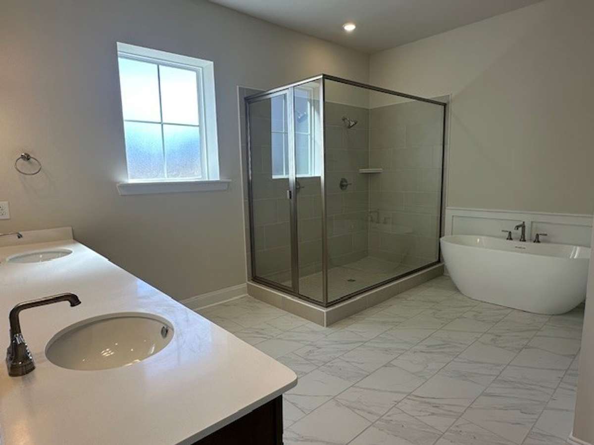A giant walk in shower complete with 2 shower heads, and a gorgeous soaking tub make your Primary Bathroom a relaxing retreat!
